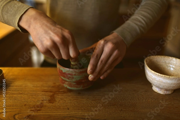 Obraz process of making matcha tea. Man's hands