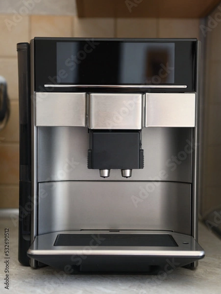 Fototapeta The automatic coffee machine is on the countertop.