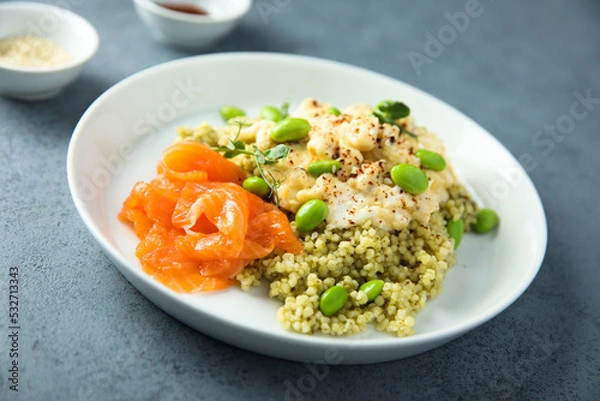 Fototapeta Scrambled eggs with couscous, salmon and beans