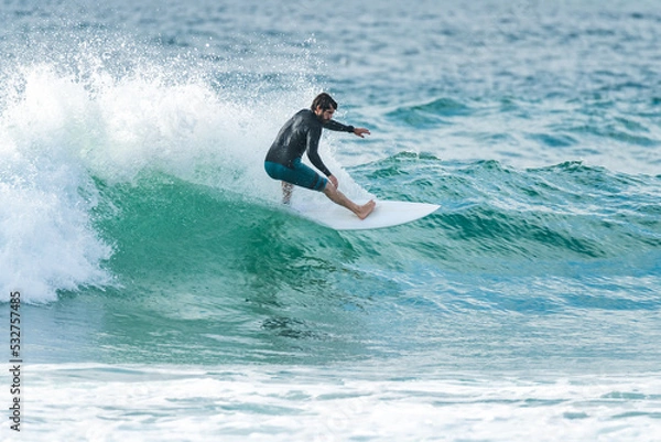 Fototapeta Local surfer riding waves