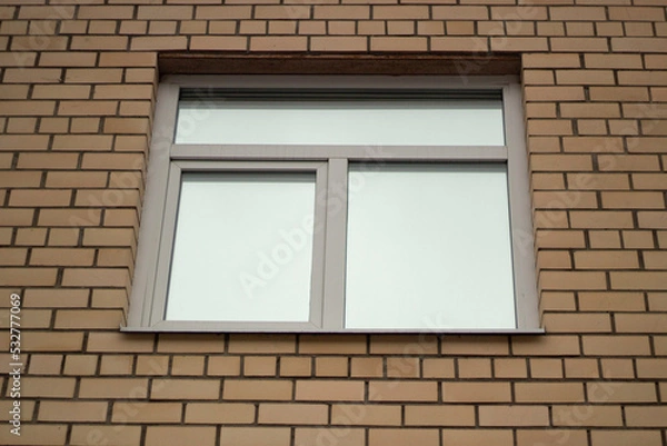 Fototapeta Window in building. Brick wall. Architecture details.