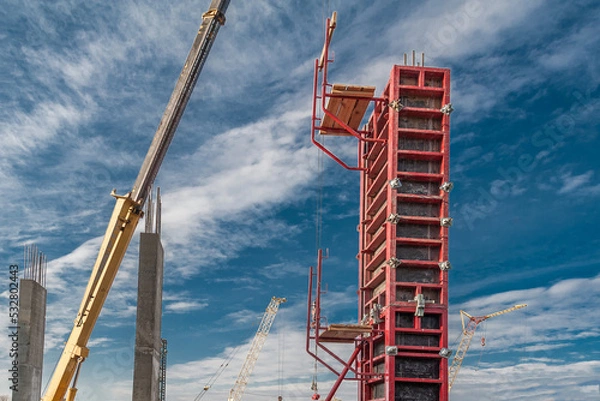 Fototapeta Mounting of column formwork with a crane.