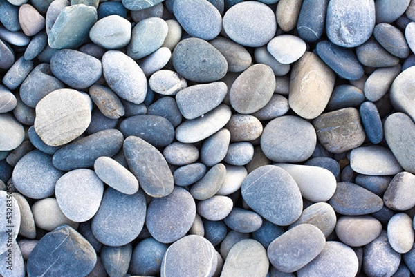 Fototapeta Abstract background with round pebble stones. Stones beach Top view.