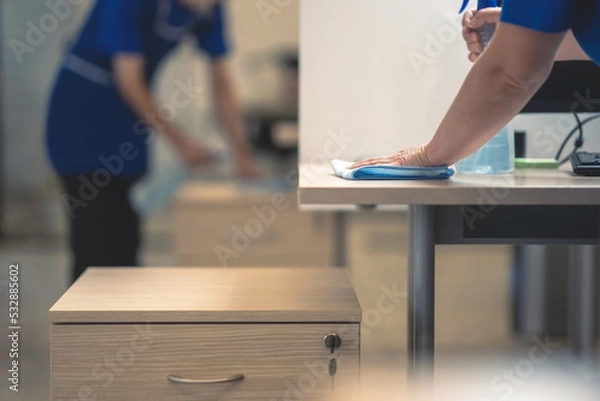 Fototapeta Hand of the cleaner cleans the office table.Cleaning concept.