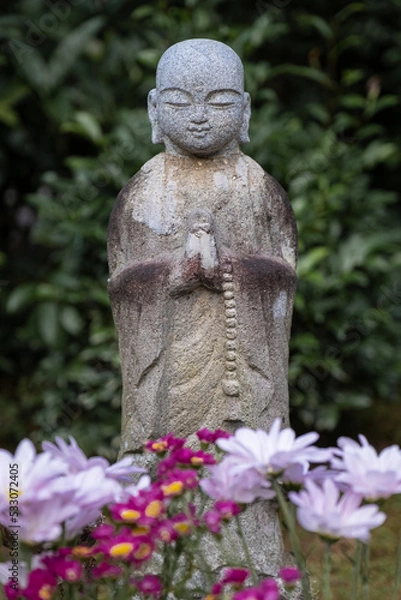 Fototapeta statue of buddha in a japanese garden