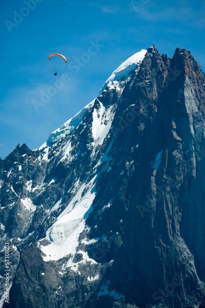 Fototapeta Red paraglide over Alps peaks