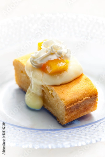 Fototapeta sponge cake with vanilla custard, peach and whipped cream
