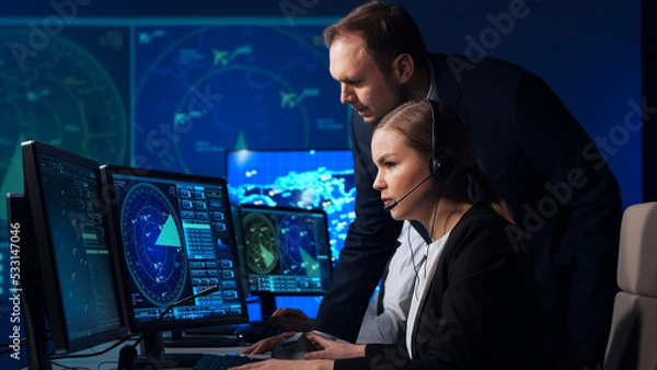 Fototapeta Workplace of the air traffic controllers in the control tower. Team of professional aircraft control officers works using radar, computer navigation and digital maps. Aviation concept.