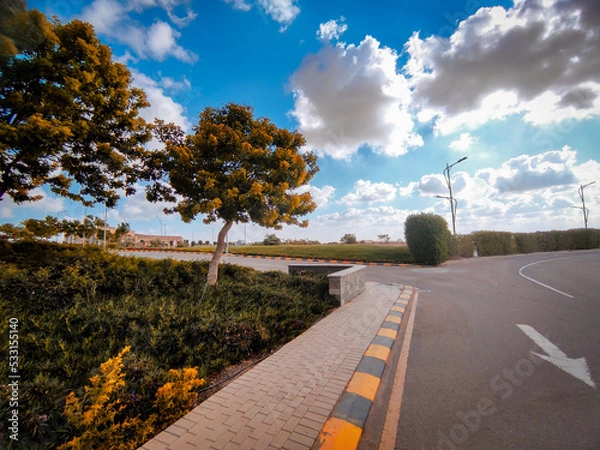 Obraz dramatic clouds and greens landscape and asphalt road
