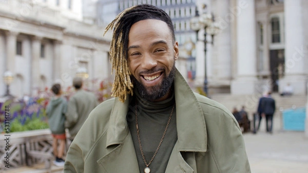 Fototapeta Portrait of handsome and stylish young man smiling to camera