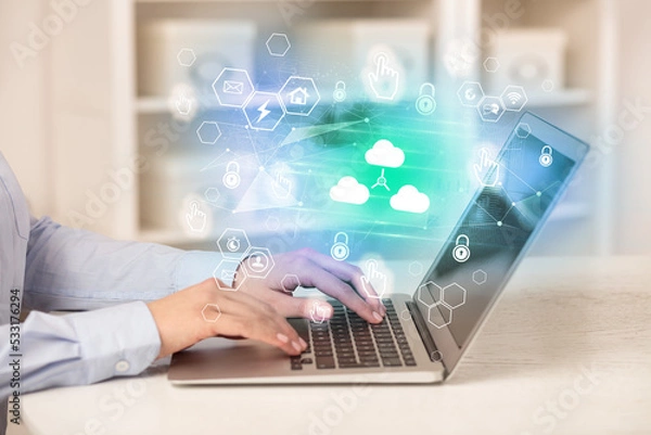 Obraz Hands working on laptop with digital icons