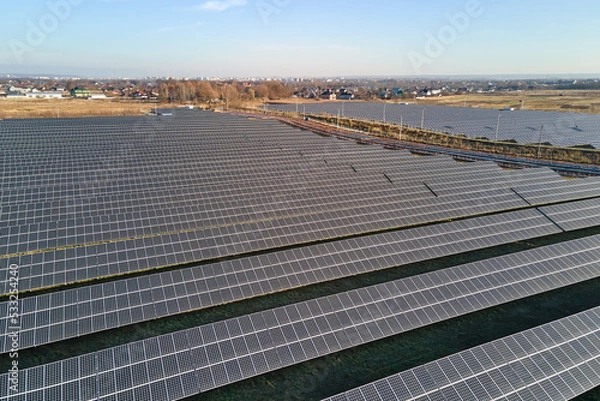 Obraz Aerial view of large sustainable electrical power plant with rows of solar photovoltaic panels for producing clean ecological electric energy. Renewable electricity with zero emission concept