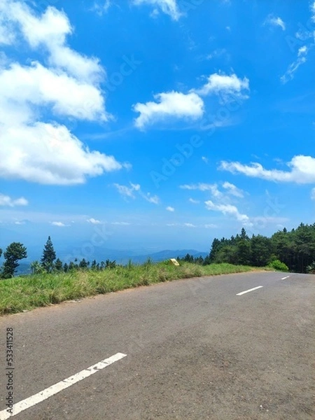 Obraz a street scene against a bright blue sky background photographed in portrait mode