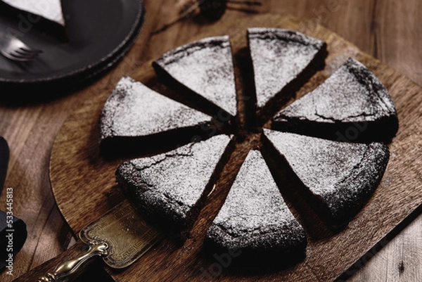 Fototapeta Kladdkaka. Traditional Swedish moist chocolate cake on wooden table. Fika. Hygge. Winter treat