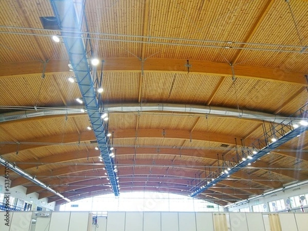 Fototapeta Wooden vaulted ceiling of the hall, with reflectors and air conditioning