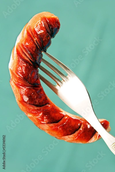 Fototapeta Grilled sausage on a fork.