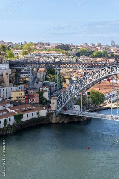Obraz Part of the Dom Luis I bridge in Porto, with people walking on the bridge, on a sunny day.