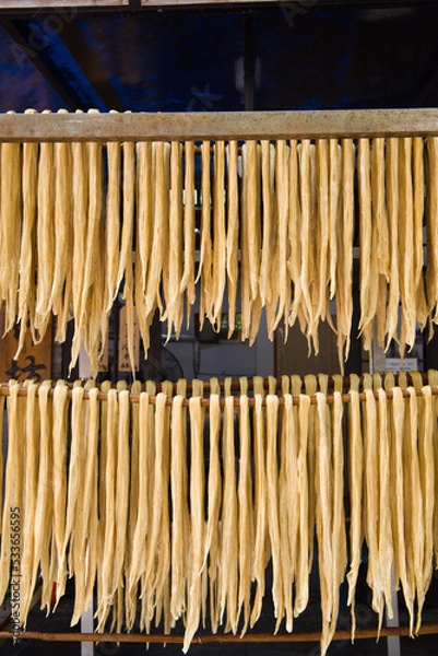 Fototapeta Dried yuba sticks hanging on shelf,beancurd stick made.