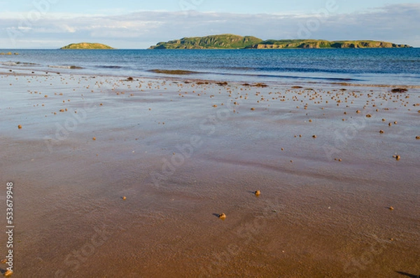 Fototapeta Evening light on Scottish beach at Southend near the Mull of Kintyre with Sanda Island and Sheep Island and copy space