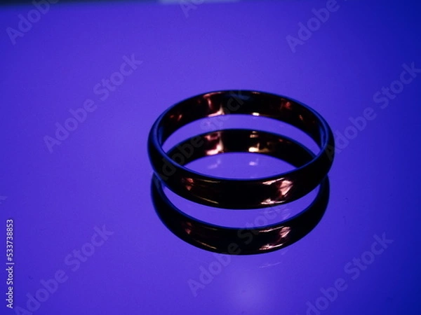 Obraz Rings with fire reflection on blue background