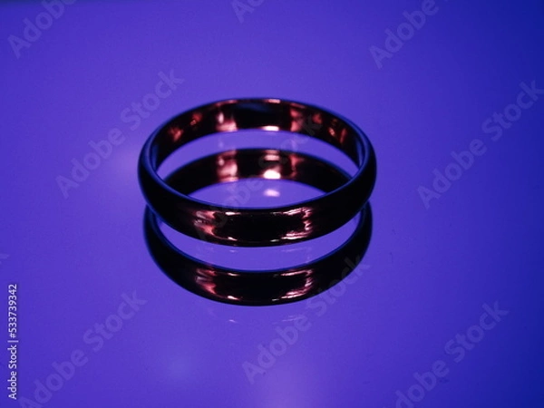 Obraz Rings with fire reflection on blue background