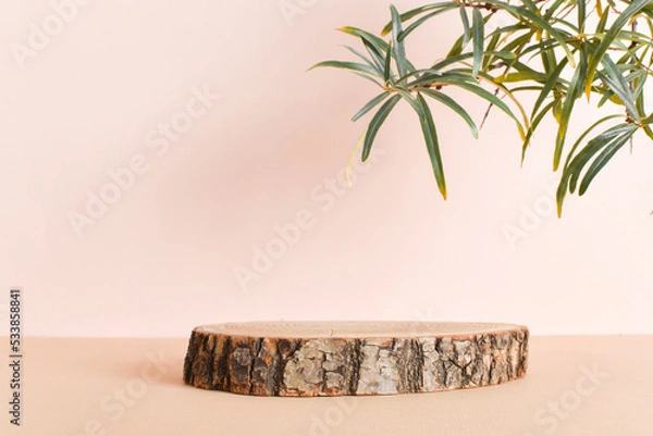 Fototapeta Wooden podium for the presentation of eco-products. A showcase made of natural wood on a beige background