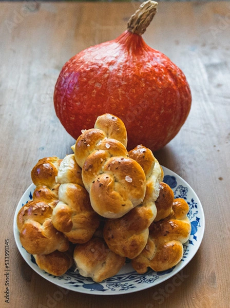 Obraz Baked buns with pumpkin in background