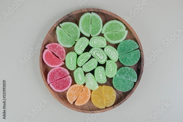 Obraz A wooden board full of colorful sugary marmalades