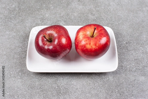 Obraz Two red apples on white plate