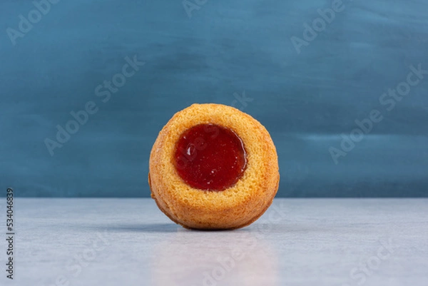 Fototapeta Small cake with jelly filling on marble background