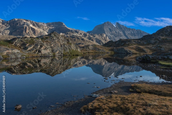 Fototapeta the beautiful reflection of the surrounding mountains in the waters of the Bellecombe lake in the Vanoise massif in the French Alps