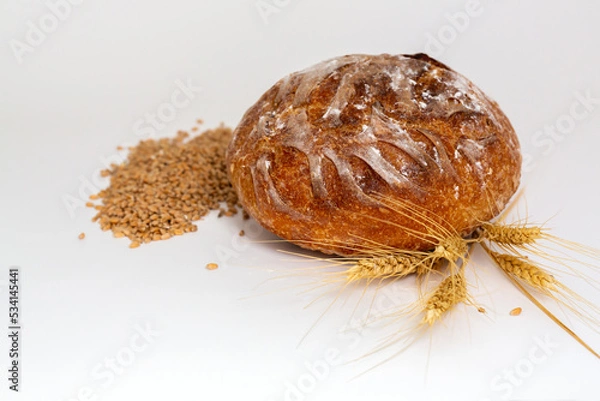Obraz Baked bread and wheat. White background.