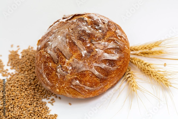 Obraz Baked bread and wheat. White background.