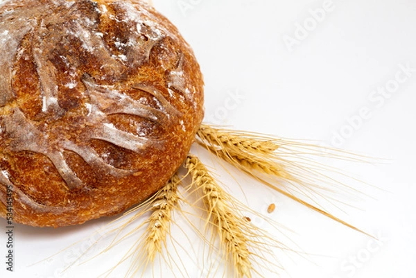 Obraz Baked bread and wheat. White background.