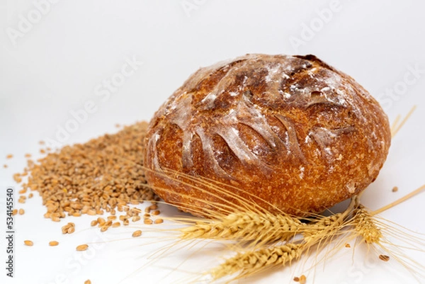 Obraz Baked bread and wheat. White background.
