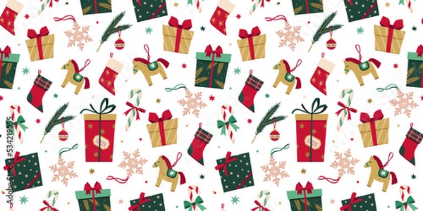 Fototapeta Vector seamless pattern with Christmas decoration in flat style. New Year stylish background of Christmas gift boxes, presents, socks, toys, candy cane, snowflake, fur tree branch, stars and confetti.