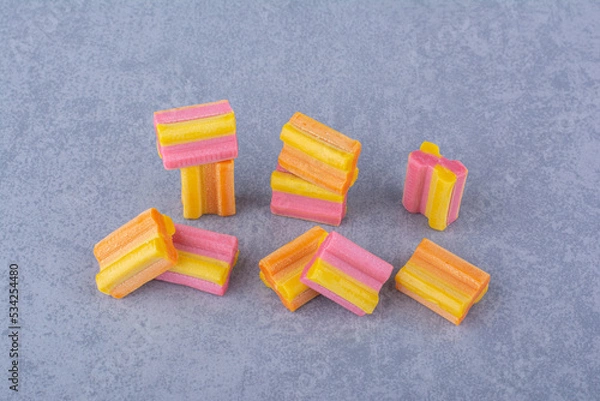 Fototapeta Handful of colorful chewing gum pieces on marble background