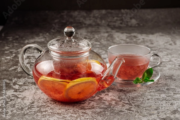 Fototapeta Tea from strawberry jam in a glass teapot