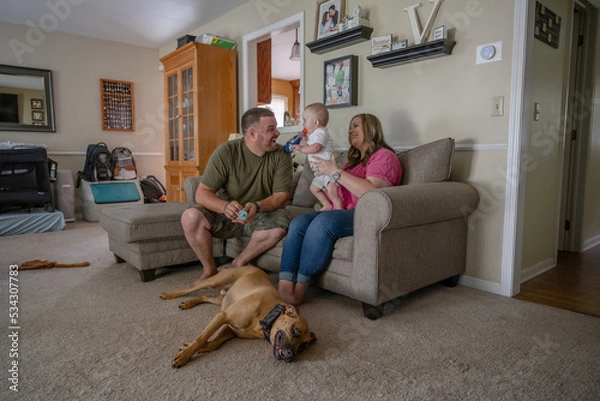 Fototapeta Marine veteran with service dog and family living life.
