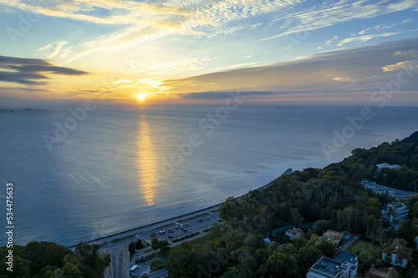 Obraz The sun rises over Gdansk Bay in Gdynia from the side of the city boulevard, aerial photo