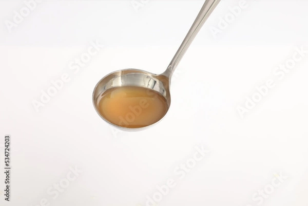 Fototapeta spoon isolated on white background. chicken stock on spoon.