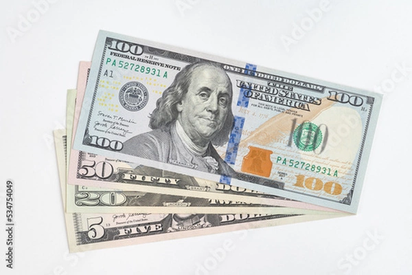 Fototapeta 5, 20, 50, 100 dollars banknotes at different angles. Close up of dollars on white background.