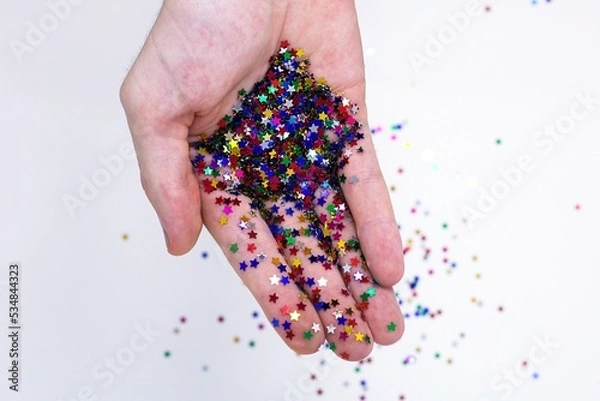 Obraz Bunte Glitzer Sterne in einer Hand