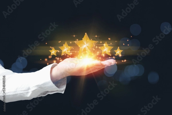 Fototapeta Hand of a man with feedback evaluation to five stars satisfaction. Rating to excellent the popular service with copy space. Customer service evaluation and satisfaction concept.