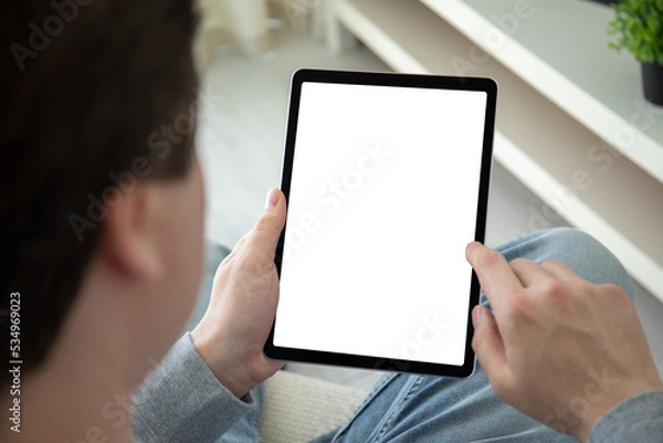 Fototapeta male hands hold computer tablet with isolated screen background room