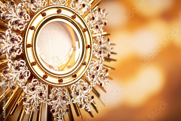 Fototapeta Catholic religion concept. Catholic symbols composition. Monstrance on yellow bokeh background. 