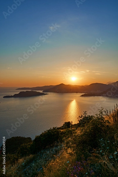 Obraz sunset over the sea in montenegro with hills in the background