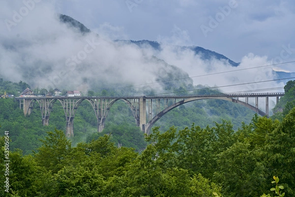 Obraz tall long bridge over the river in the mountains