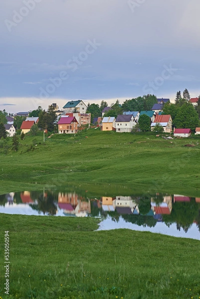 Obraz reflection of a little village on the surface of a lake