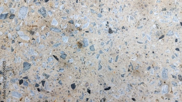 Fototapeta Concrete background with pebbles on surface